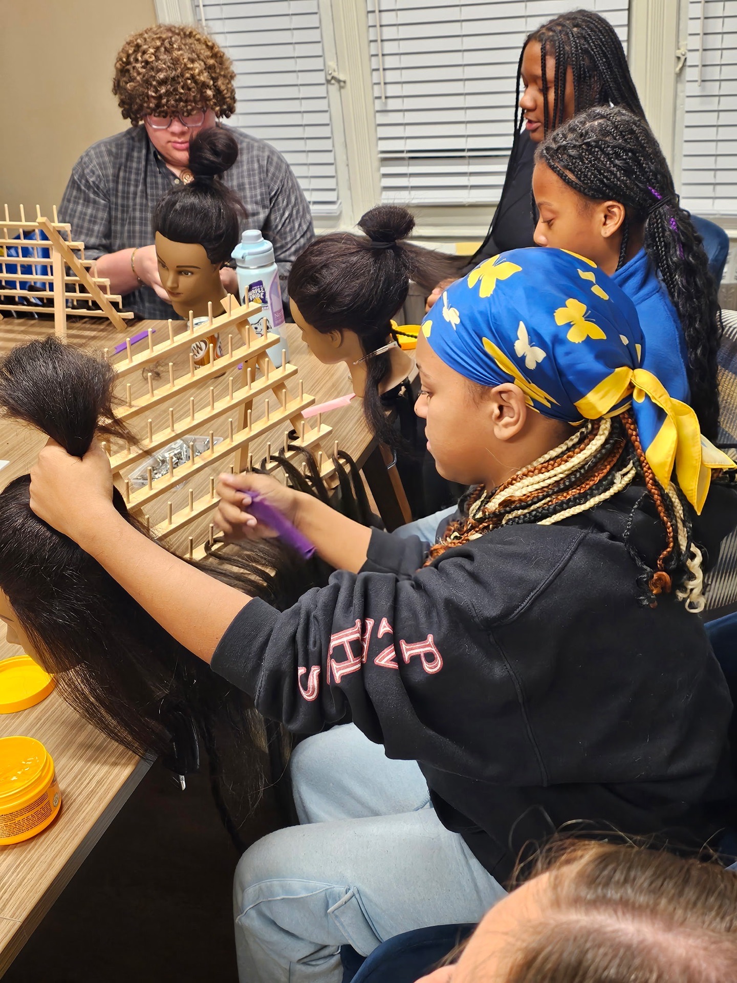 Participants practicing braiding techniques